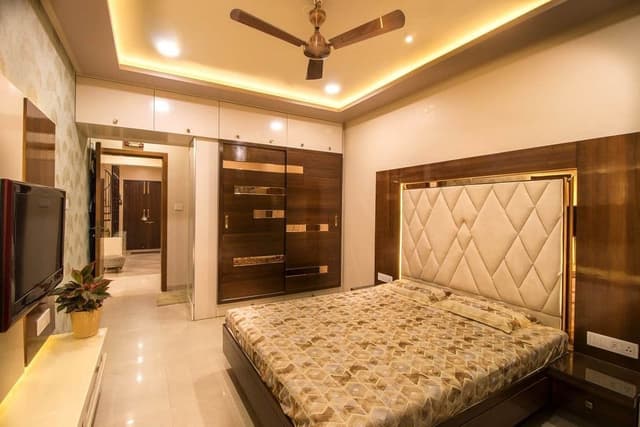 A-Bed-with-Diagonally-Tufted-Off-White-Coloured-Squares-on-the-High-Headboard-with-Wooden-Laminate-Beside-it-2-Side-Table-with-1-Drawers-on-Each-Side Swiper Content 0