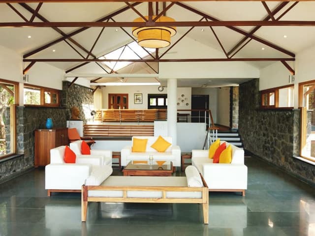 A-Living-Room-having-an-Elegant-View-of-River-Nature-surround-accommodating-White-Coloured-Square-Armed-Sofa Swiper Content 1