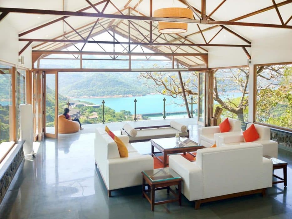 A-Living-Room-having-an-Elegant-View-of-River-Nature-surround-accommodating-White-Coloured-Square-Armed-Sofa. Design Detail Banner 0