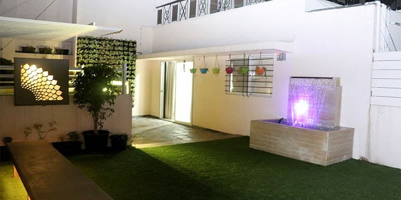 A-Lush-Green-Lawn-with-a-Stone-Finish-Fixed-Seatings-highlighted-by-Recessed-Lighting-2 Design Detail Banner 1