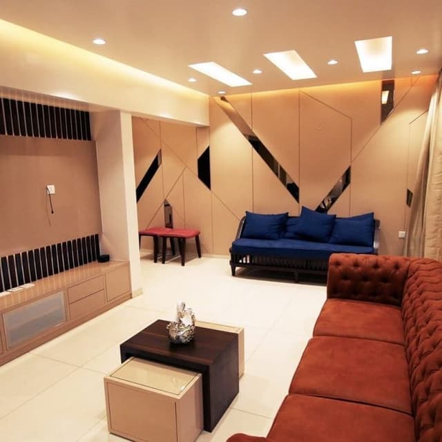 A-Maroon-Chesterfield-Sofa-Wooden-Frame-Sofa-with-Blue-Cushioned-Seating-are-adding-a-Charm-to-this-Living-Room. Swiper Content 0