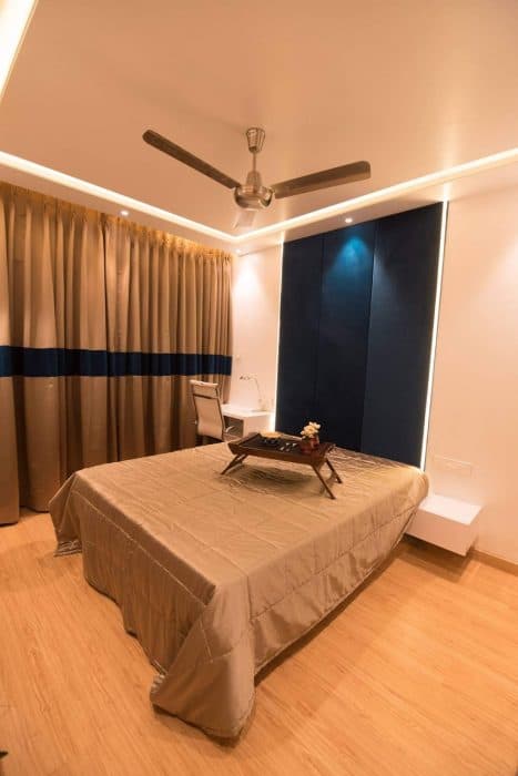 A-Simple-Minimalistic-Bedroom-with-a-custom-made-Wooden-Double-Bed-with-ceiling-Fitted-Velvet-Navy-Blue-Coloured-Upholstered-Headboard Swiper Content 0