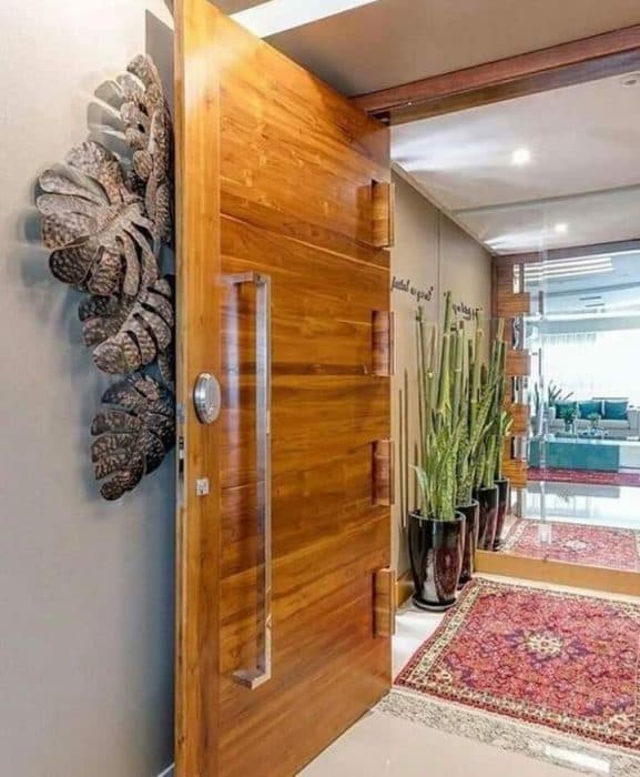 A-wooden-Door-having-Horizontal-wooden-figures-with-S.S.-long-Handle-is-allowing-you-to-enter-the-Foyer-Space. Swiper Content 0