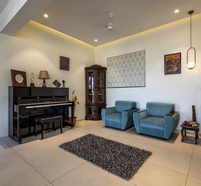 An-Area-incorporating-Blue-Shaded-Upholstered-Sofa-Chairs-Low-Heighted-Wooden-Side-Tables Swiper Content 0