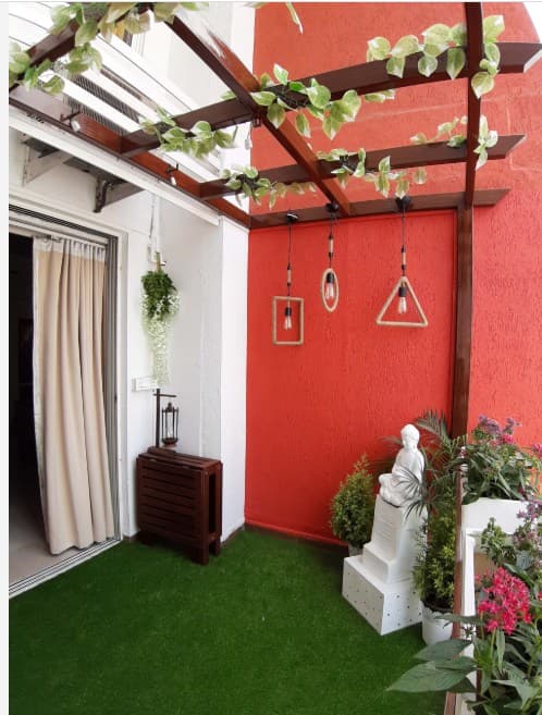 Balcony-designed-with-Artificial-Grass-Mat-on-the-Floor-with-Pedestal-Statue-of-Buddha-in-White-Bamboo-Sticks-on-one-side-over-White-Pebbles-tied-with-a-Thread-3 Balcony designed with Artificial Grass Mat on the Floor