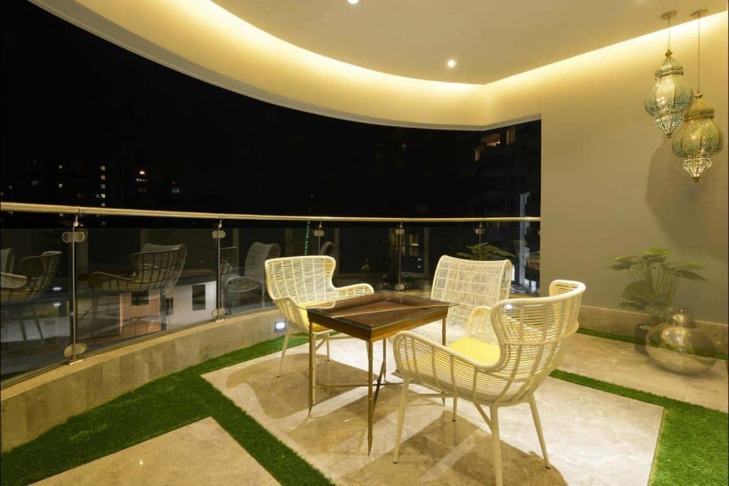 Balcony-with-Circular-Edge-having-Glass-Railing-Metal-Handrail-comprises-of-Stone-Flooring Design Detail Banner 0