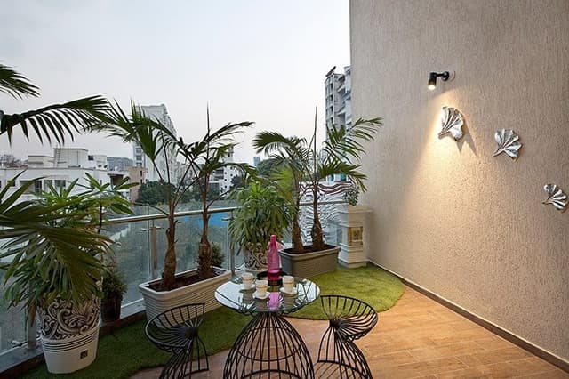 Balcony-with-Glass-Railing-Metal-Handrail-comprises-of-Wooden-Flooring-Artificial-Turf-Flooring Swiper Content 0