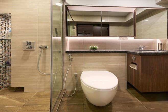 Bathroom-incorporating-Under-Counter-Wash-Basin-Black-Granite-Countertop-Wooden-Cabinet-under-it-Wall-Mounted-Rectangular-Storage-with-Mirror-highlighted-with-Cove-Lights. Design Detail Banner 0