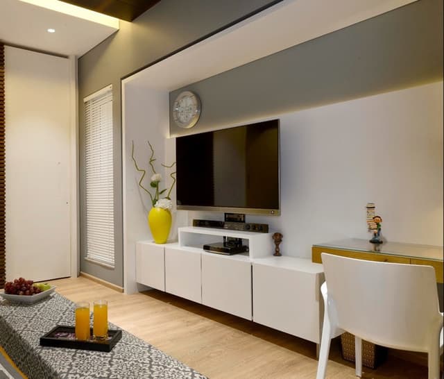 Bedroom-TV-Unit-placed-in-Niche-comprises-of-Wooden-Wall-Panelling-highlighted-with-Cove-Light Swiper Content 0