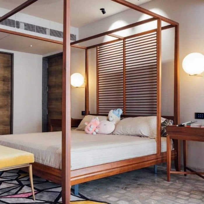 Bedroom-accommodating-Wooden-Canopy-Double-Bed-with-Wooden-Headboard-and-Screen-Bench-Bed-at-the-end-of-the-Bed-Wooden-High-Side-Tables-POP-False-Ceiling-with-Surface-Spot-Lights. Design Detail Banner 0