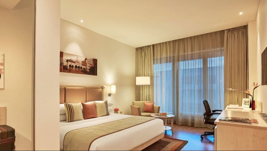 Bedroom-designed-in-Beige-Theme-with-Platform-Bed-Bed-Runner-High-Upholstered-Headboard-Side-Tables-Wooden-Working-Desk-Armchair Design Detail Banner 0