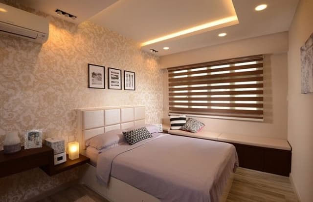 Bedroom-in-the-Neutral-Theme-of-Cream-incorporating-a-Wooden-Bed-Cushioned-Headboard-Wooden-Shelf-with-Drawers-Textured-Wallpaper-with-Wall-Paintings-hung-Window-with-Horizontal-Blinds Swiper Content 0