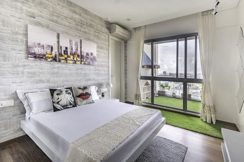 Bedroom-with-Artificial-Turf-Wooden-Flooring-comprises-of-Solid-White-Double-Bed-Side-Table-Upholstered-Headboard-1 Design Detail Banner 0