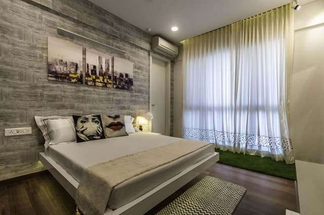 Bedroom-with-Artificial-Turf-Wooden-Flooring-comprises-of-Solid-White-Double-Bed-Side-Table-Upholstered-Headboard-2 Swiper Content 1