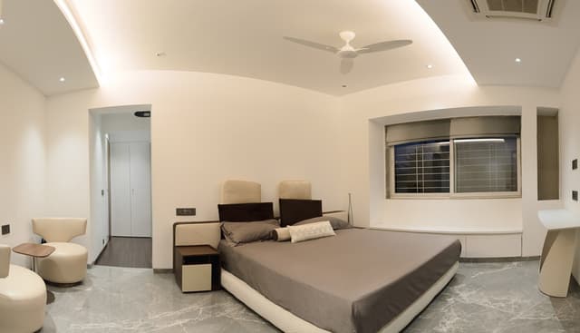 Bedroom-with-Grey-Tile-Flooring-comprises-of-Upholstered-King-Sized-Bed-with-Cushioned-Headboard Swiper Content 0