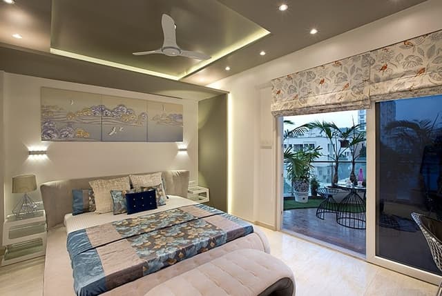 Bedroom-with-Lush-Balcony-incorporating-Upholstered-Platform-Bed-with-Storage-Tufted-Bed-End-Bench-Floor-Mounted-Side-Tables-with-Table-Lamps.-1 Swiper Content 0