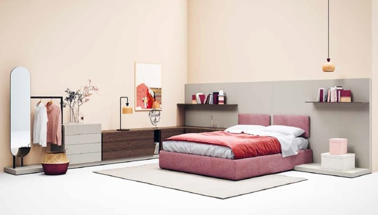 Bedroom-with-Pink-Upholstered-Double-Bed-with-Headboard-Floor-Level-Modern-Side-Table-on-one-side-and-Linear-Cabinets-with-Table-Lamp-on-the-other-side-of-Bed-Linear-Shelves-on-Wall. Design Detail Banner 0