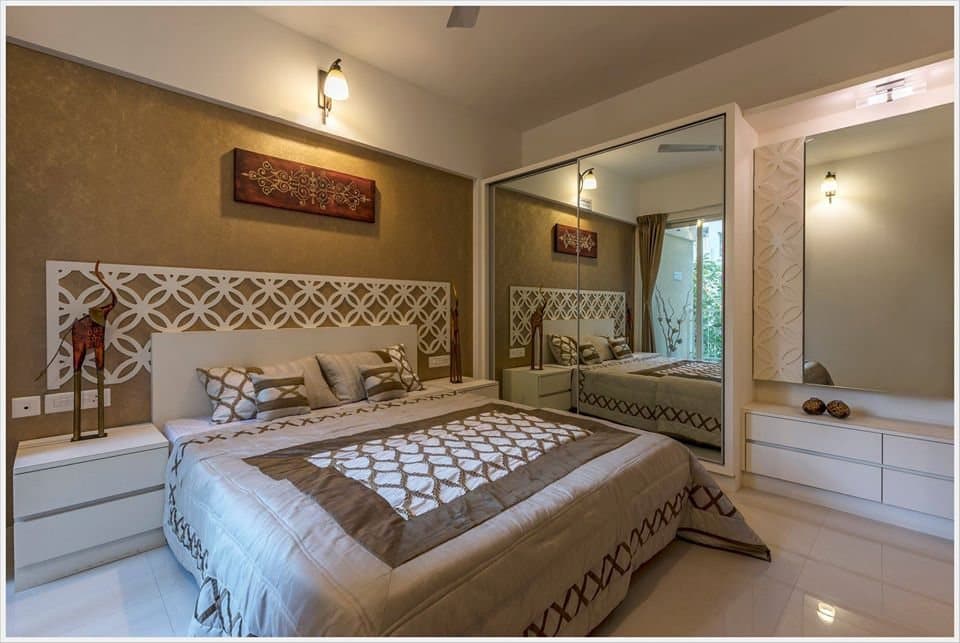 Bedroom-with-Wooden-Double-Bed-Wooden-Headboard-Floor-Mounted-Wooden-Side-Tables-with-Antiques-Bed-Back-Wall-highlighted-with-Wallpaper. Design Detail Banner 0