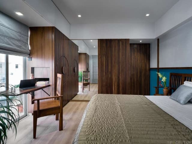 Bedroom-with-Wooden-Flooring-comprises-of-Wooden-Double-Bed-Folding-Wooden-Study-Table-with-Solid-Wood-Chair Swiper Content 0