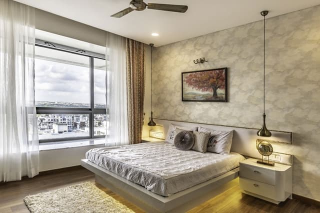 Bedroom-with-Wooden-Flooring-comprises-of-Wooden-Double-Bed-with-Storage-below-highlighted-with-Cove-Light-1 Swiper Content 0