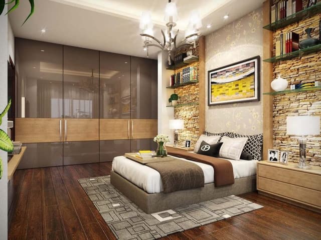 Bedroom-with-an-Upholstered-Bed-Side-Tables-with-Drawers-above-Wall-Face-is-Cladded-with-stone-Glass-Shelves-for-Decor-Items Bedroom with an Upholstered Bed