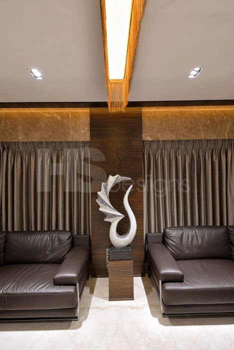 Big-Living-Room-incorporating-Classic-Dark-Brown-Leather-Square-Armed-Sofa-Set-with-Center-Full-Glazed-Coffee-Tables-Side-Table-with-Showpiece-Sofa-Back-Wall-with-Big-Window-having-Drapes Design Detail Banner 1