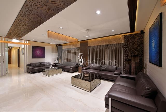 Big-Living-Room-incorporating-Classic-Dark-Brown-Leather-Square-Armed-Sofa-Set-with-Center-Full-Glazed-Coffee-Tables-Side-Table-with-Showpiece-Sofa-Back-Wall-with-Big-Window-having-Drapes. Swiper Content 0