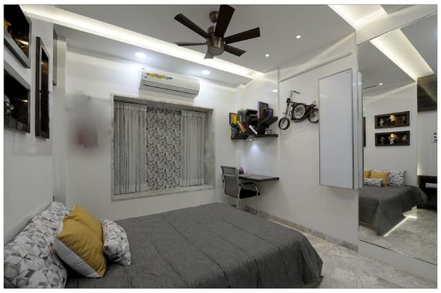 Black-White-theme-in-Teenagers-Bedroom-accommodating-Wooden-Bed-with-Printed-Cushions-01 Swiper Content 0