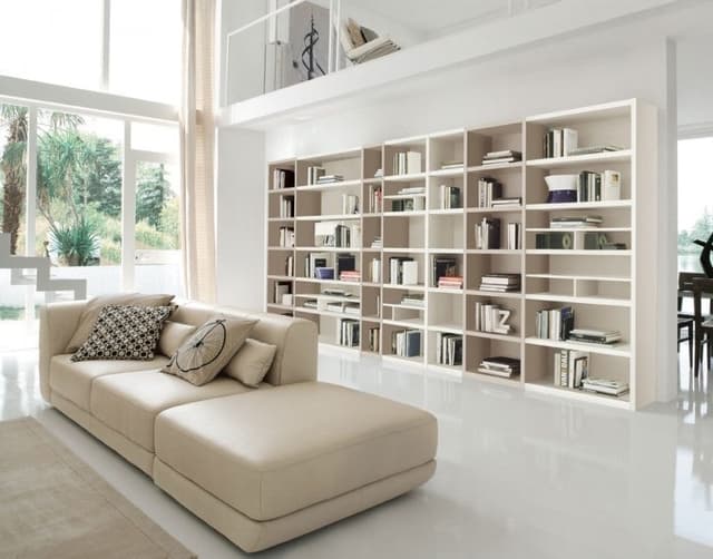 Book-Display-with-Couch-is-giving-a-User-a-Space-to-get-Relax-Read.-The-whole-Space-has-a-Combination-of-White-Beige. Swiper Content 0