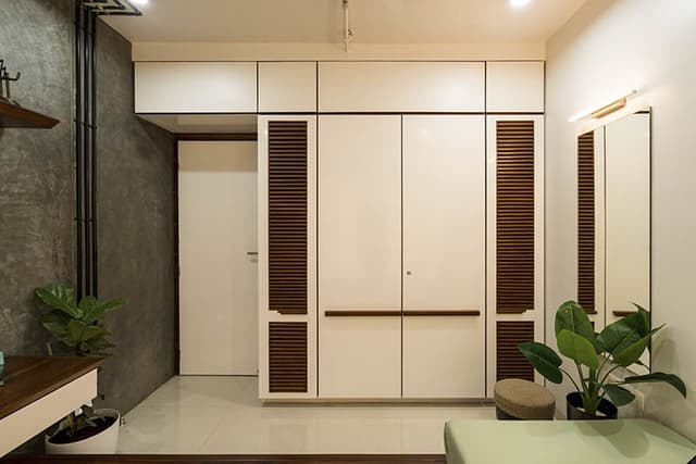 Ceiling-Fitted-Wooden-Wardrobe-with-Central-Wooden-Doors-having-Horizontal-Wooden-Handles. Swiper Content 0