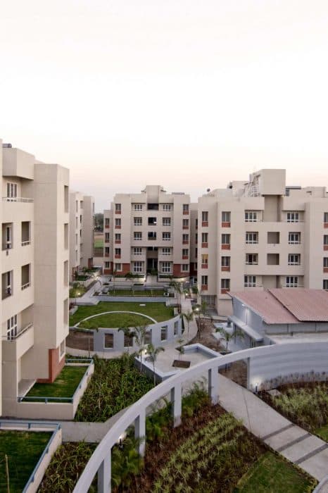 Cluster-of-5-Storeyed-Apartment-Buildings-with-Lush-Green-Lawn-in-the-center-Concrete-Pathway-leading-to-Gardens-3 Design Detail Banner 2