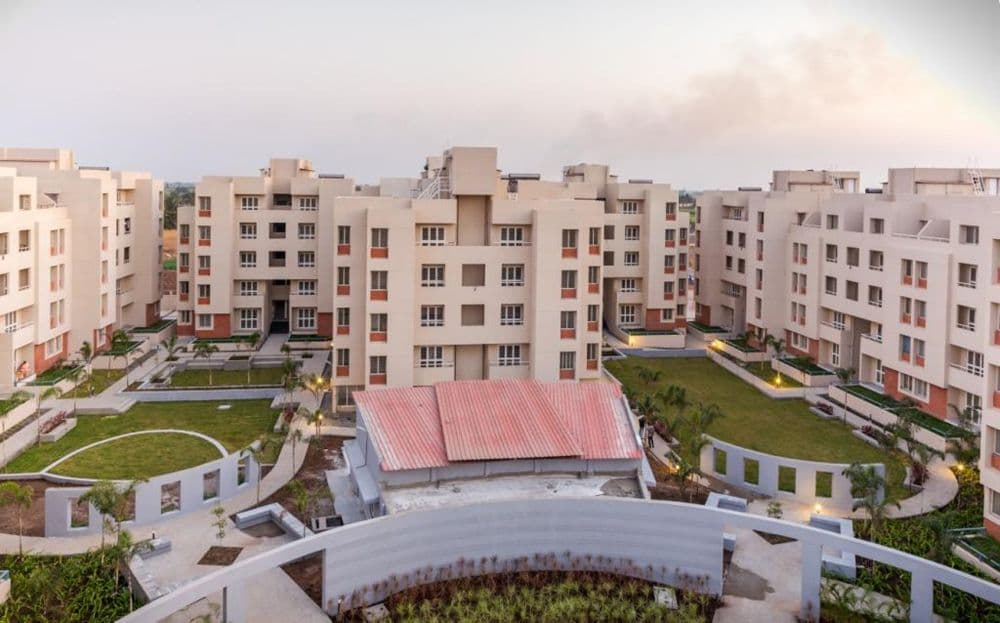 Cluster-of-5-Storeyed-Apartment-Buildings-with-Lush-Green-Lawn-in-the-center-Concrete-Pathway-leading-to-Gardens-4 Design Detail Banner 3