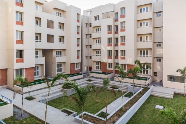Cluster-of-5-Storeyed-Apartment-Buildings-with-Lush-Green-Lawn-in-the-center-Concrete-Pathway-leading-to-Gardens-5 Swiper Content 4
