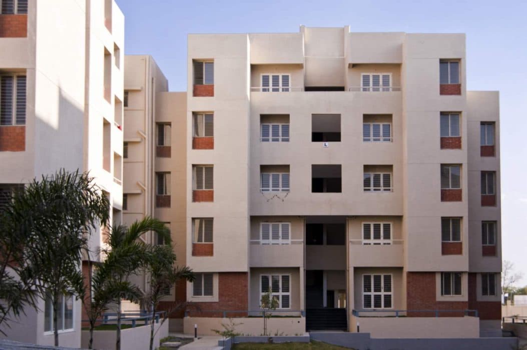 Cluster-of-5-Storeyed-Apartment-Buildings-with-Lush-Green-Lawn-in-the-center-Concrete-Pathway-leading-to-Gardens-8 Design Detail Banner 7
