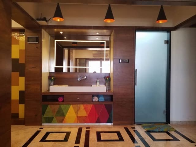 Common-Wash-Basin-Area-accommodating-Table-Top-Wash-Basin-with-Colourful-Wooden-Vanity-Cabinet-below-it Swiper Content 0