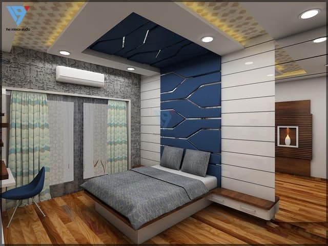 Contemporary-Bedroom-design-with-a-Wooden-Bed-Attached-Side-Tables-Bed-Backwall-Paneled-in-a-Zig-Zag-Line-with-Grooves-as-Transparent-Glass-Study-Table-1 Swiper Content 0