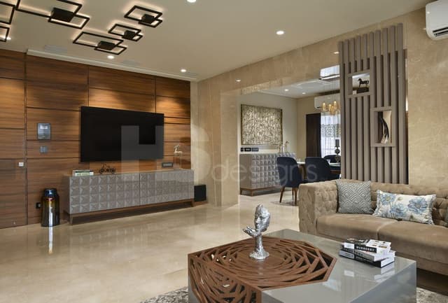 Contemporary-Living-Room-consisting-Tuxedo-Sofa-Set-Navy-Blue-Coloured-Wingback-Chairs-with-Low-Back-a-Unique-designed-Coffee-Table-with-Antique-Books-placed-on-it-1 Swiper Content 1