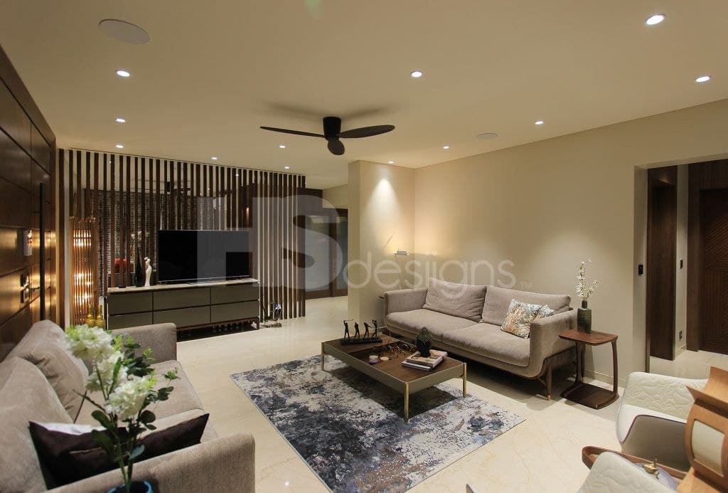 Contemporary-Living-Room-incorporating-Sofa-Set-Coffee-Table-over-a-Rug-End-Tables-with-Flower-Vases-T.V.-Unit-with-Wooden-Slits-behind-Free-Standing-Shelves-for-keeping-Antiques-Books.. Design Detail Banner 1