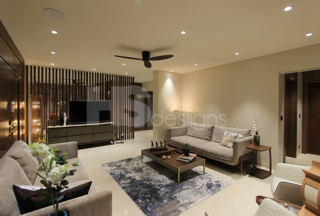 Contemporary-Living-Room-incorporating-Sofa-Set-Coffee-Table-over-a-Rug-End-Tables-with-Flower-Vases-T.V.-Unit-with-Wooden-Slits-behind-Free-Standing-Shelves-for-keeping-Antiques-Books.. Swiper Content 1