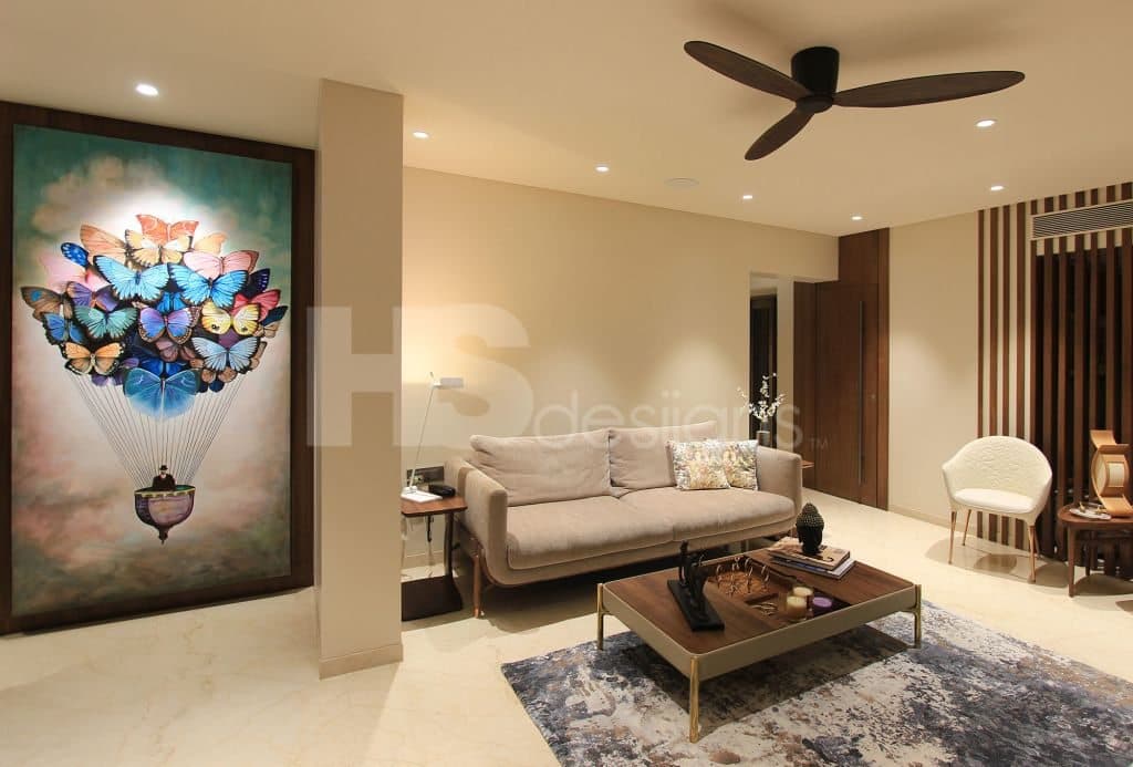 Contemporary-Living-Room-incorporating-Sofa-Set-Coffee-Table-over-a-Rug-End-Tables-with-Flower-Vases-T.V.-Unit-with-Wooden-Slits-behind-Free-Standing-Shelves-for-keeping-Antiques-Books Design Detail Banner 2