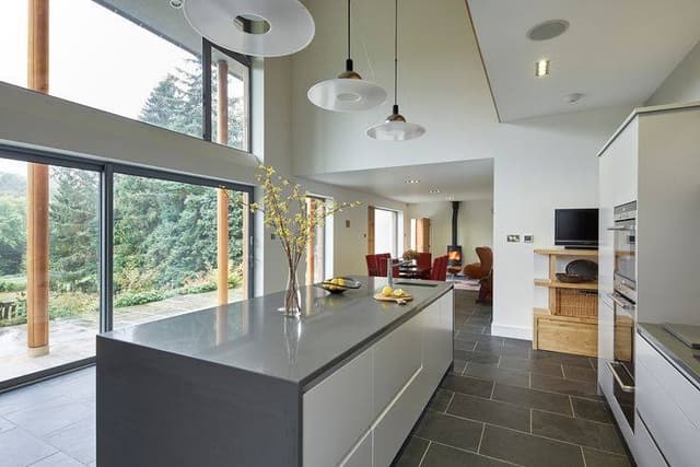 Contemporary-Open-concept-Kitchen-Living-Room-comprising-a-Single-Wall-Kitchen-with-an-Rectangular-Island-consist-of-Single-Bowl-SS-Sink-Pendant-Lights-Decor-Vase-on-top-of-it Contemporary Open concept Kitchen