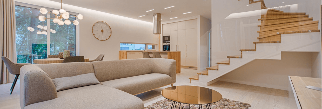 Contemporary-styled-Living-Room-in-Cream-Theme-incorporating-Sectional-Sofa-Round-Metallic-Center-Table-placed-on-a-Rug Design Detail Banner 0