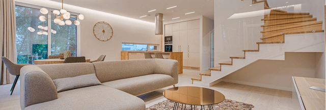 Contemporary-styled-Living-Room-in-Cream-Theme-incorporating-Sectional-Sofa-Round-Metallic-Center-Table-placed-on-a-Rug Swiper Content 0