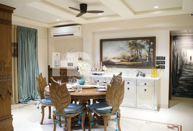 Dining-Room-accommodating-Circular-Wooden-Dining-Table-Wooden-Chair-with-Cushioned-Seating-and-Leaf-Shaped-Wooden-Backrest-Floor-Mounted-Cabinet-for-Storage. Swiper Content 0