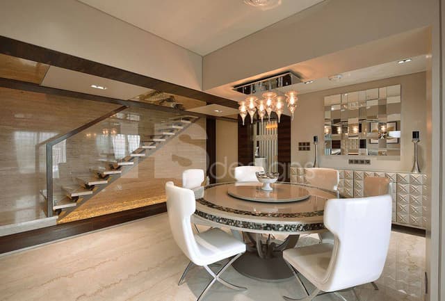 Dining-Room-incorporating-6-Seater-Revolving-Circular-Dining-Table-with-Marble-Top-and-Metal-Base-White-Cushioned-Dining-Chairs-with-Metal-Legs. Swiper Content 0