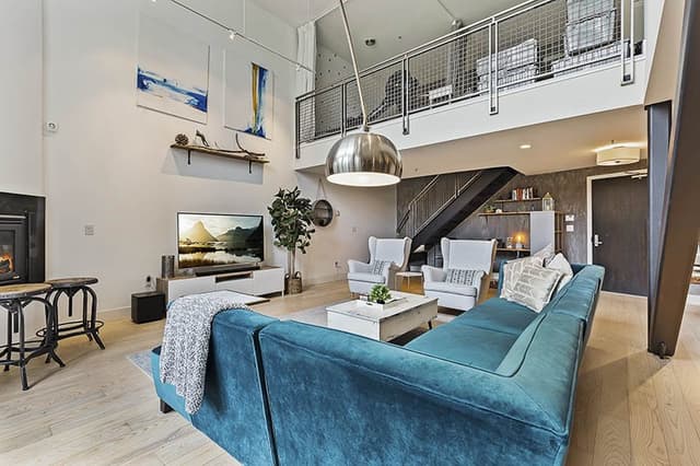 Double-Heighted-Living-Room-with-Glazed-Facade-Wooden-Flooring-comprises-of-Sea-Blue-Velvet-Fabric-Upholstered-Sectional-Sofa-with-Right-Facing-Chaise-2 Swiper Content 5