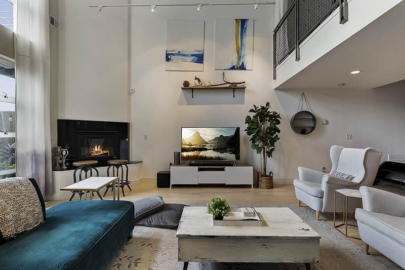 Double-Heighted-Living-Room-with-Glazed-Facade-Wooden-Flooring-comprises-of-Sea-Blue-Velvet-Fabric-Upholstered-Sectional-Sofa-with-Right-Facing-Chaise.-2 Design Detail Banner 4