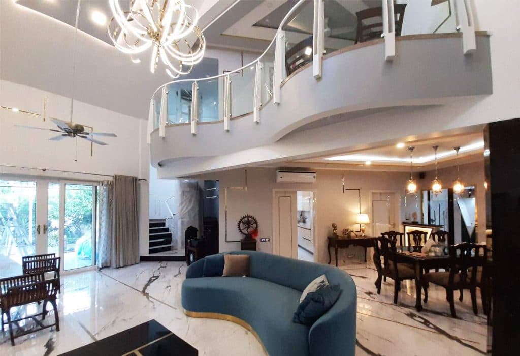 Double-Heighted-Living-Room-with-Marble-Flooring-highlighted-with-Metal-Strip-Inlay-Light-Blue-Low-Back-Upholstered-Sofa-with-Golden-Metal-Base-1 Design Detail Banner 2