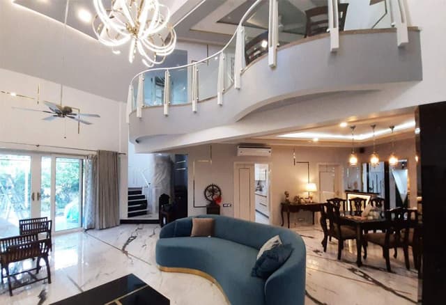 Double-Heighted-Living-Room-with-Marble-Flooring-highlighted-with-Metal-Strip-Inlay-Light-Blue-Low-Back-Upholstered-Sofa-with-Golden-Metal-Base-1 Swiper Content 2