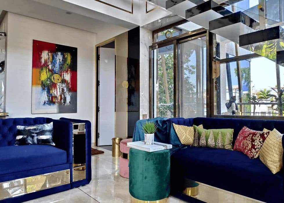 Double-Heighted-Luxurious-Open-Plan-Living-Room-with-Glass-Facade-incorporates-Royal-Blue-Sofa-Set-with-Sofa-Cum-Bed-facility Design Detail Banner 2